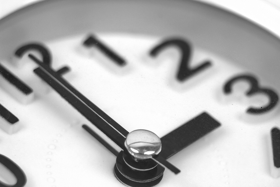 Macro Photo Of Clock Marking Winter Time Change Over White Backg