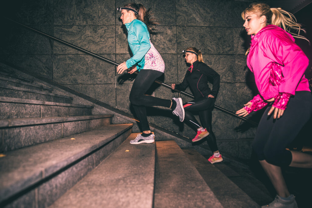 Three Women Running In The Night In The City Center